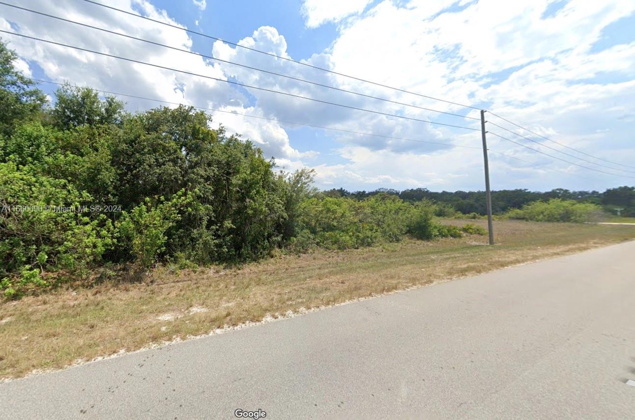 a view of a road with a big yard