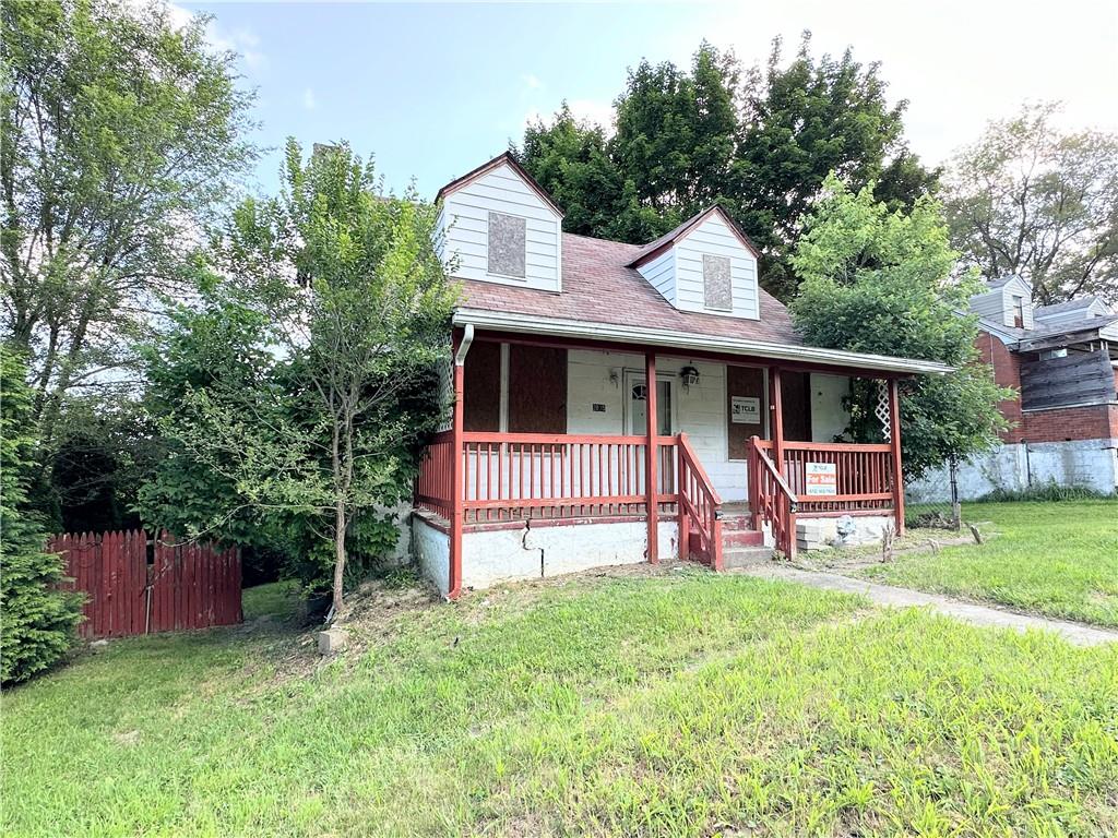 a view of a house with a yard and deck