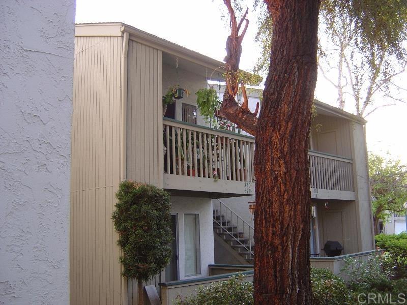 a view of a house with a tree front of house