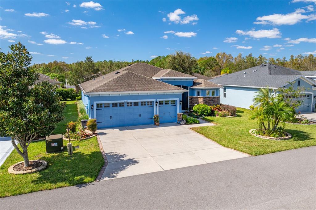 a front view of a house with a yard and garage