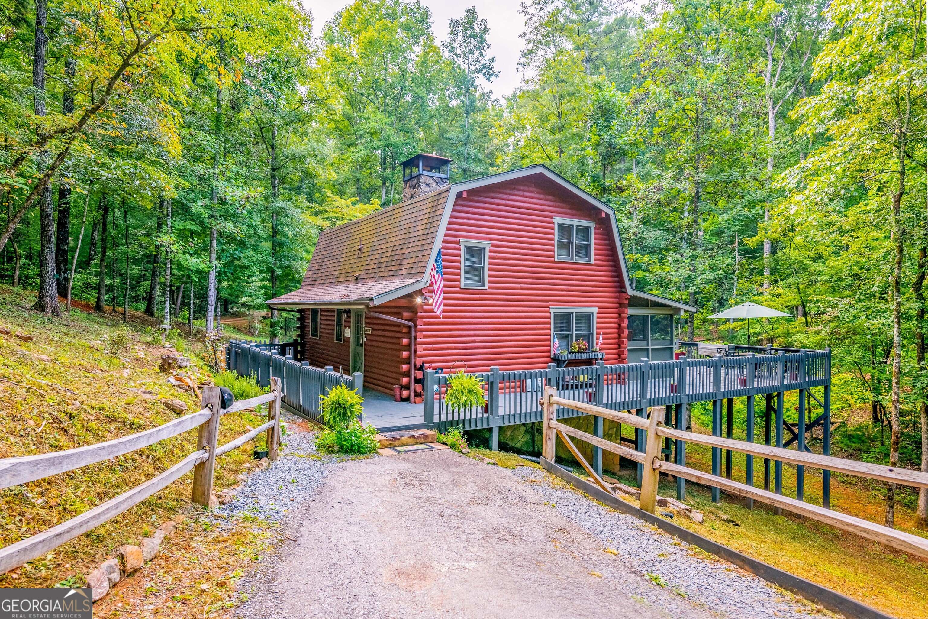 a view of a house with a yard and sitting area