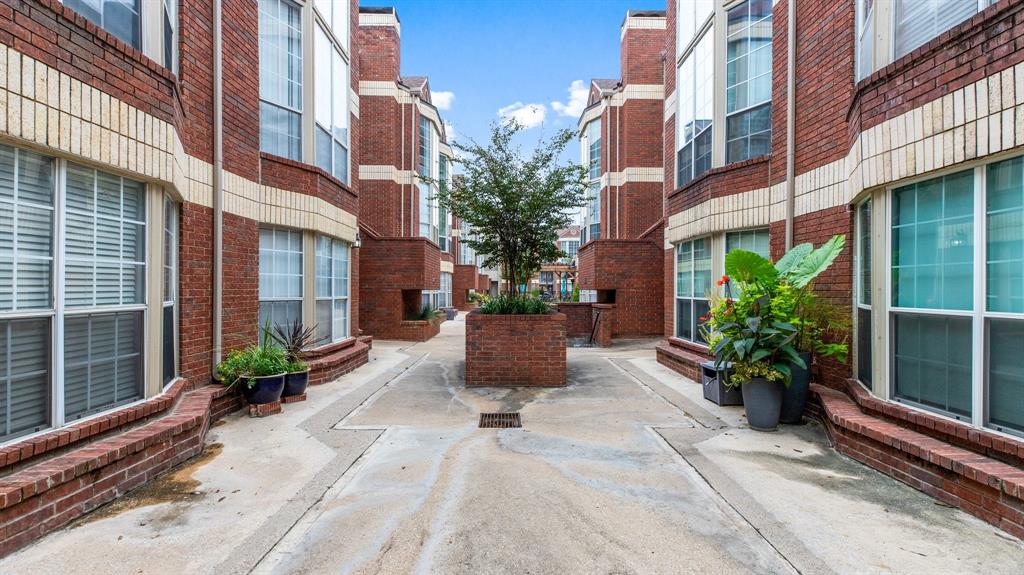 a view of a building with potted plants