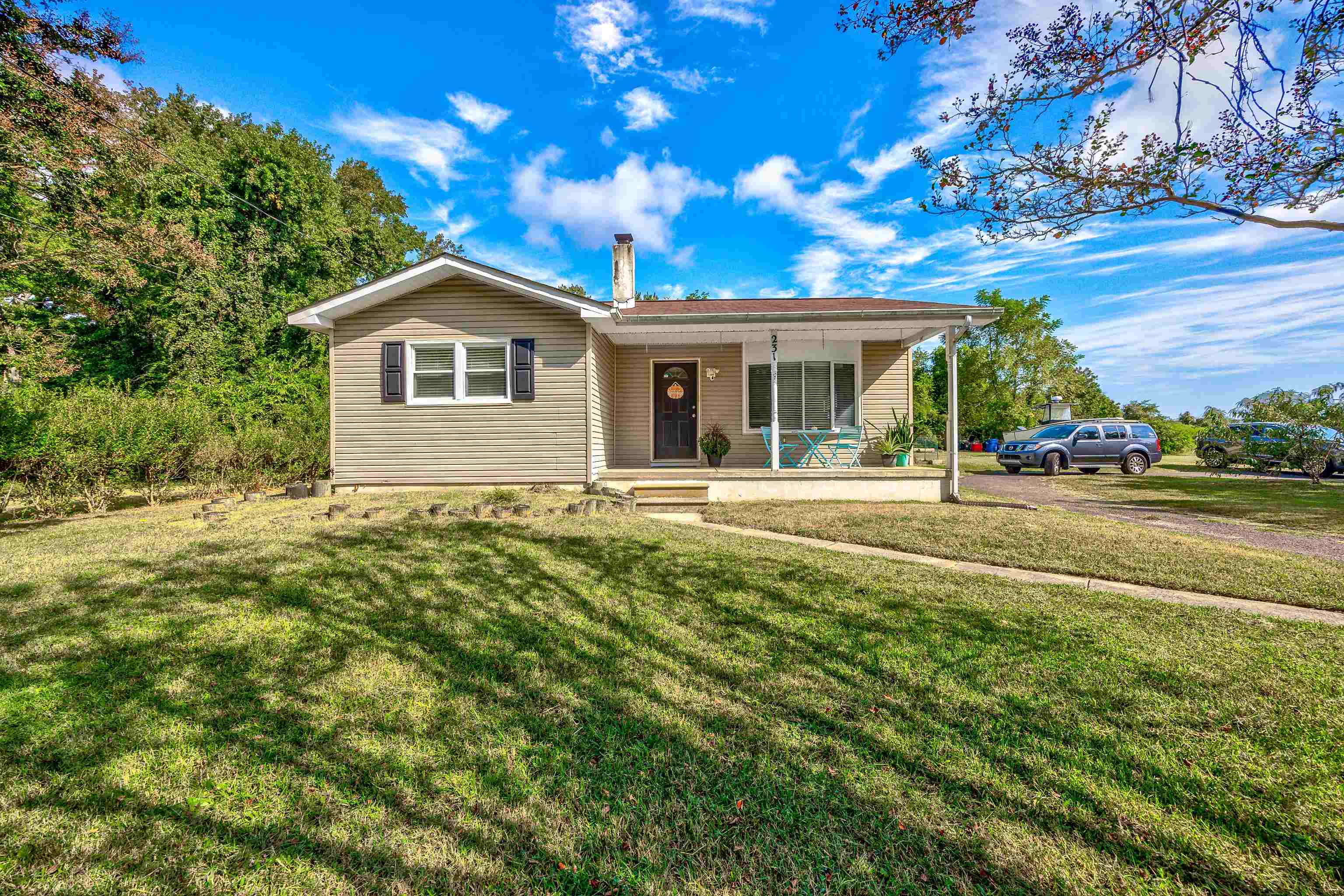 a front view of house with yard and green space