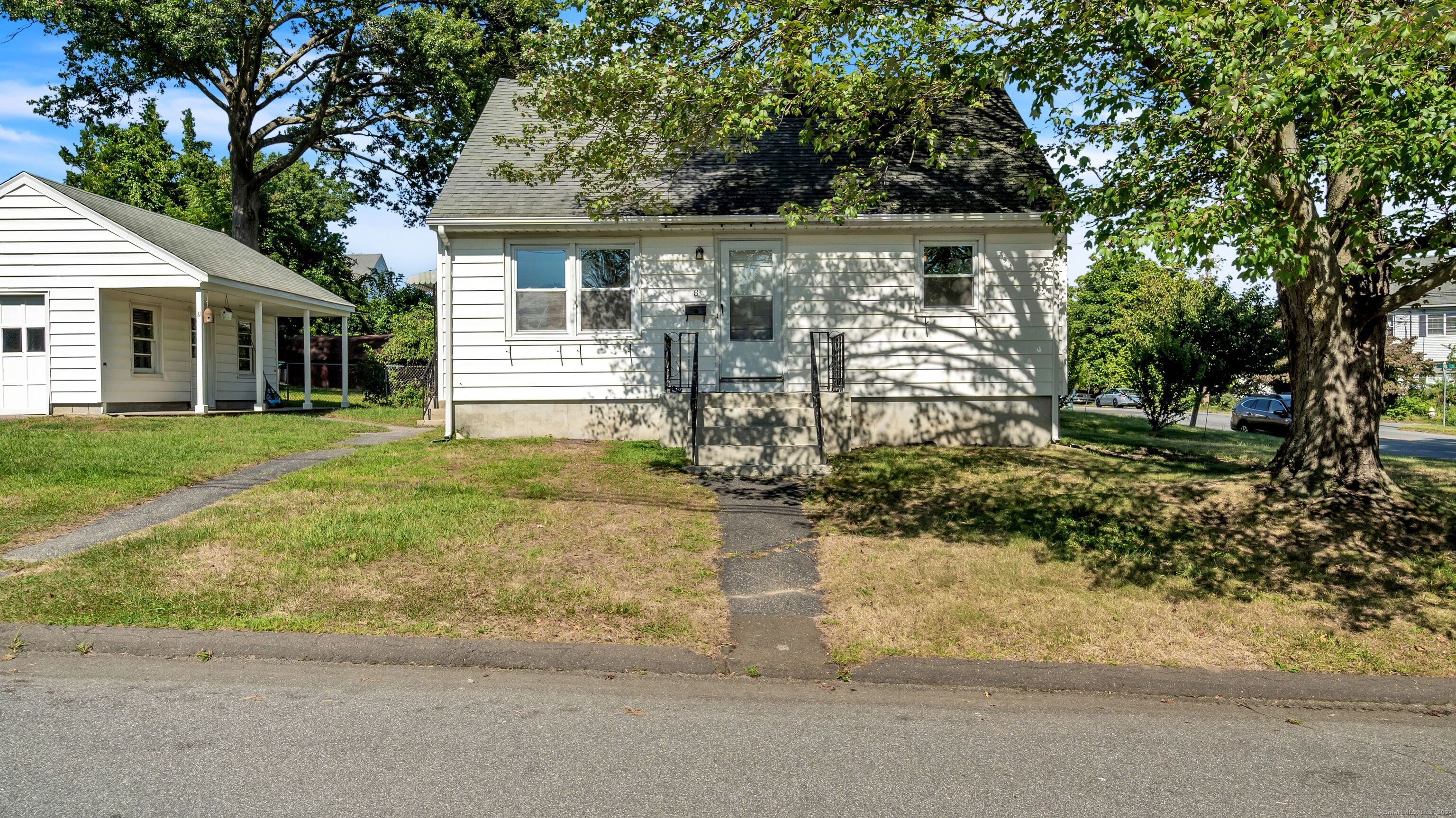 a front view of house with yard and green space