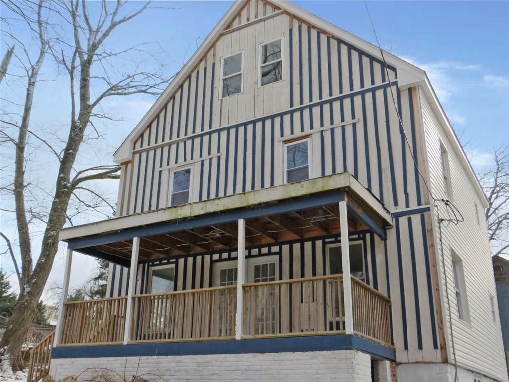 a view of a house with wooden floor fence and a large windows