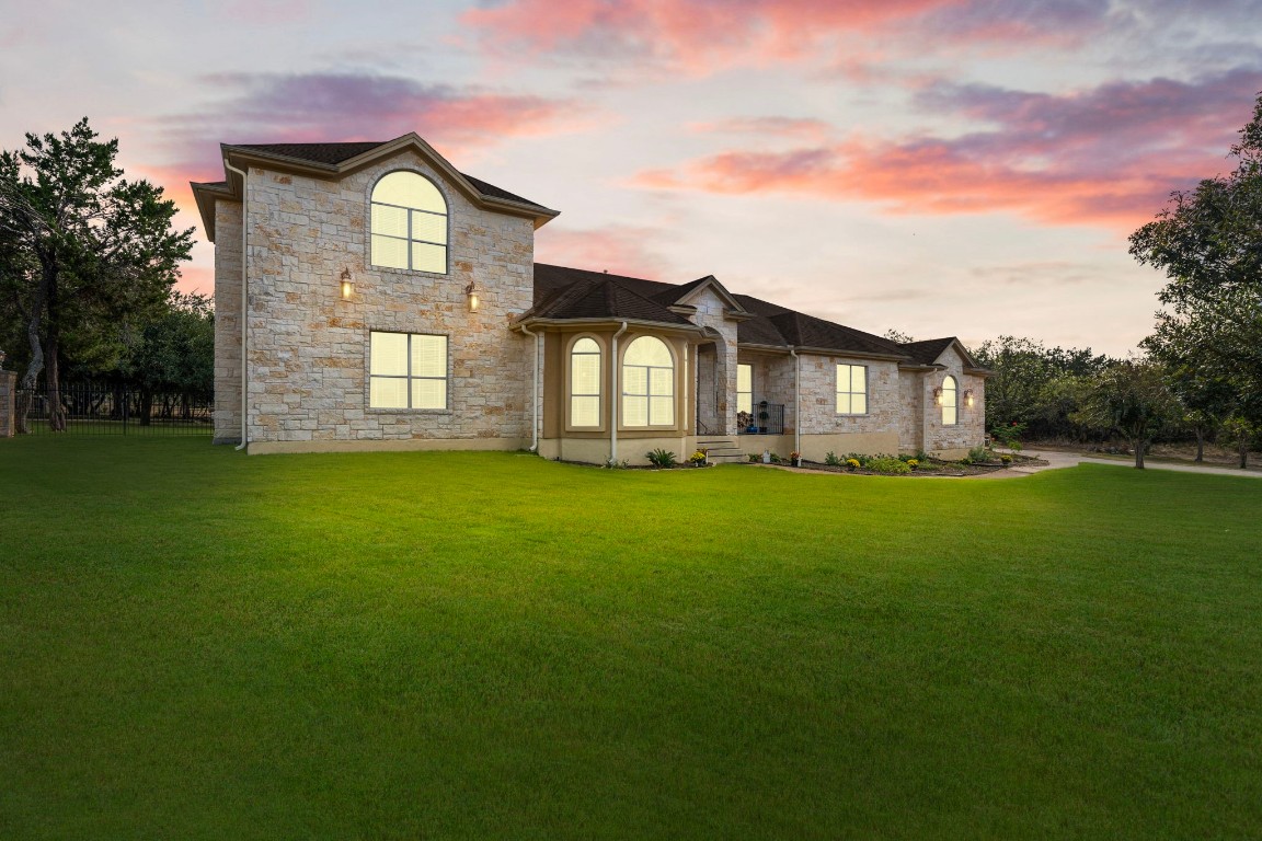 a front view of a house with a garden and yard