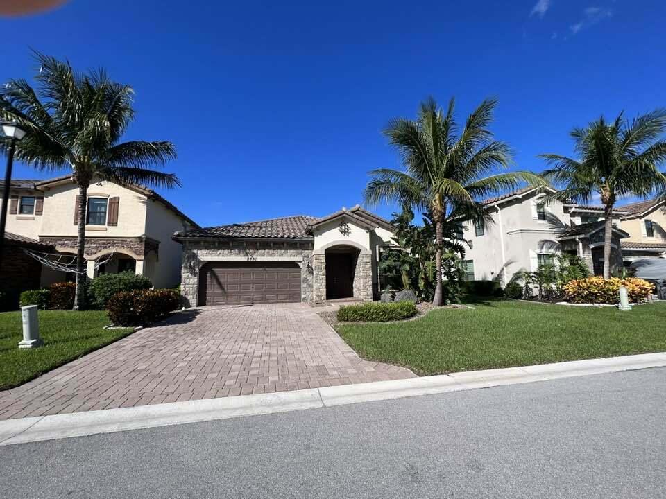 a front view of a house with a yard and garage