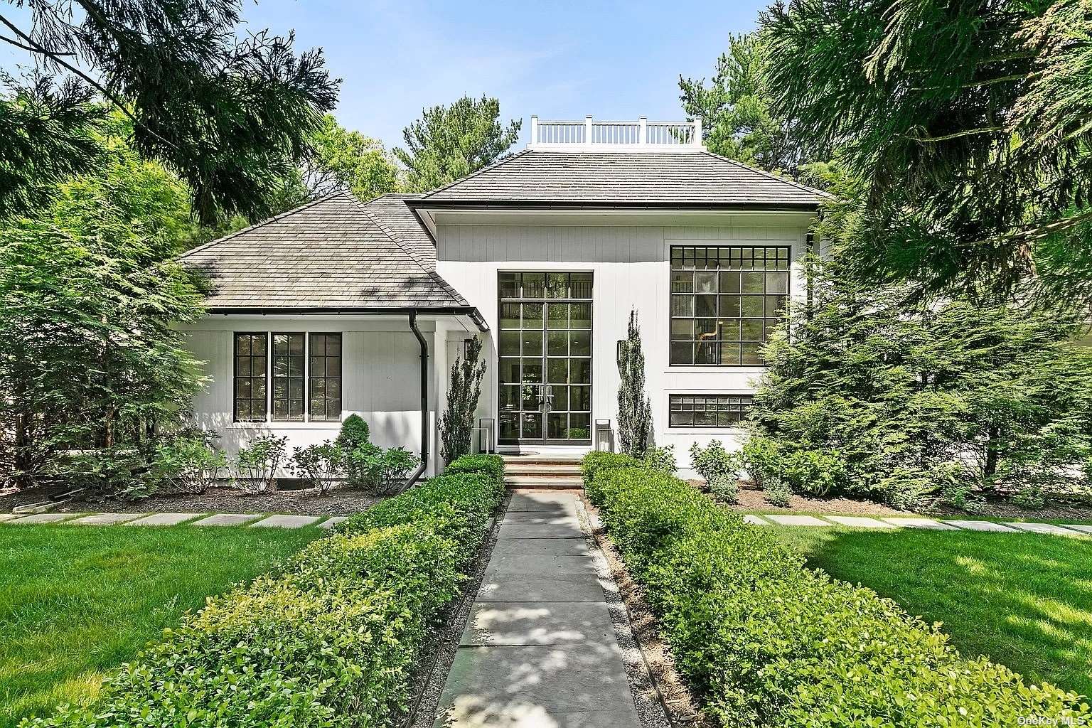 a front view of a house with a yard and porch