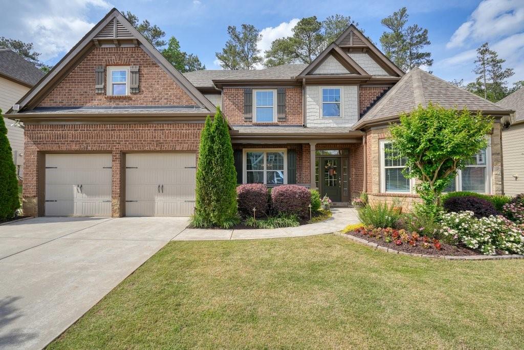 a front view of a house with a yard and garage