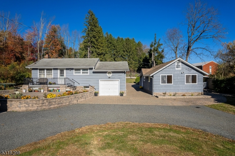 a view of house with outdoor space and parking