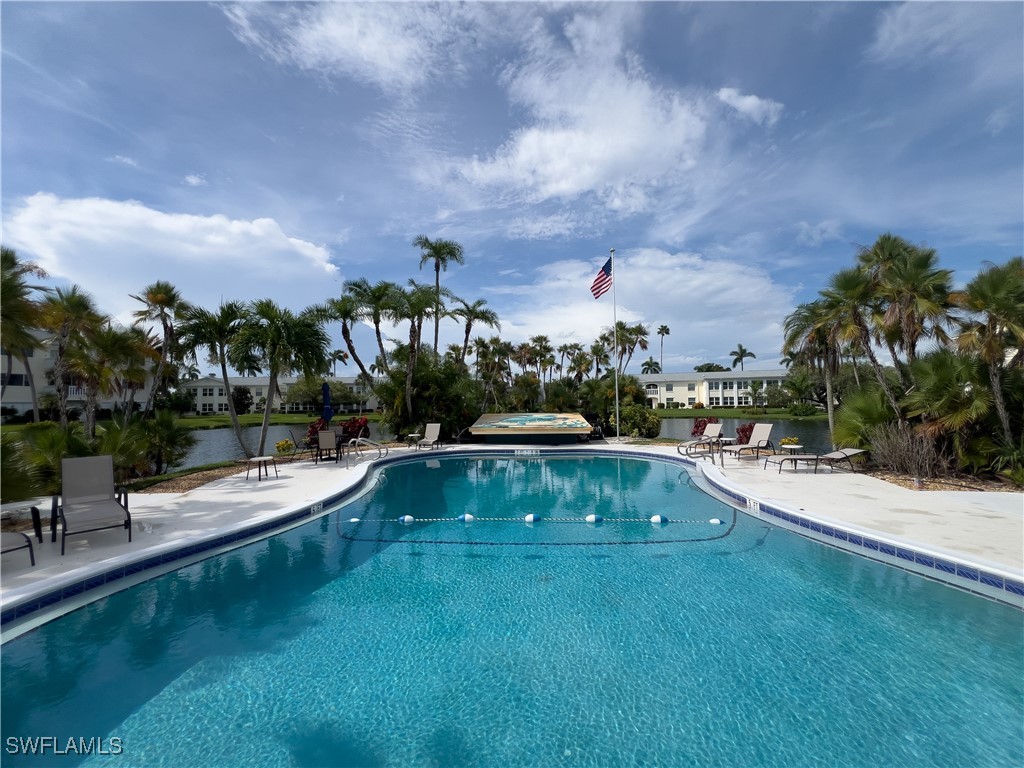 a view of a swimming pool and lounge chairs