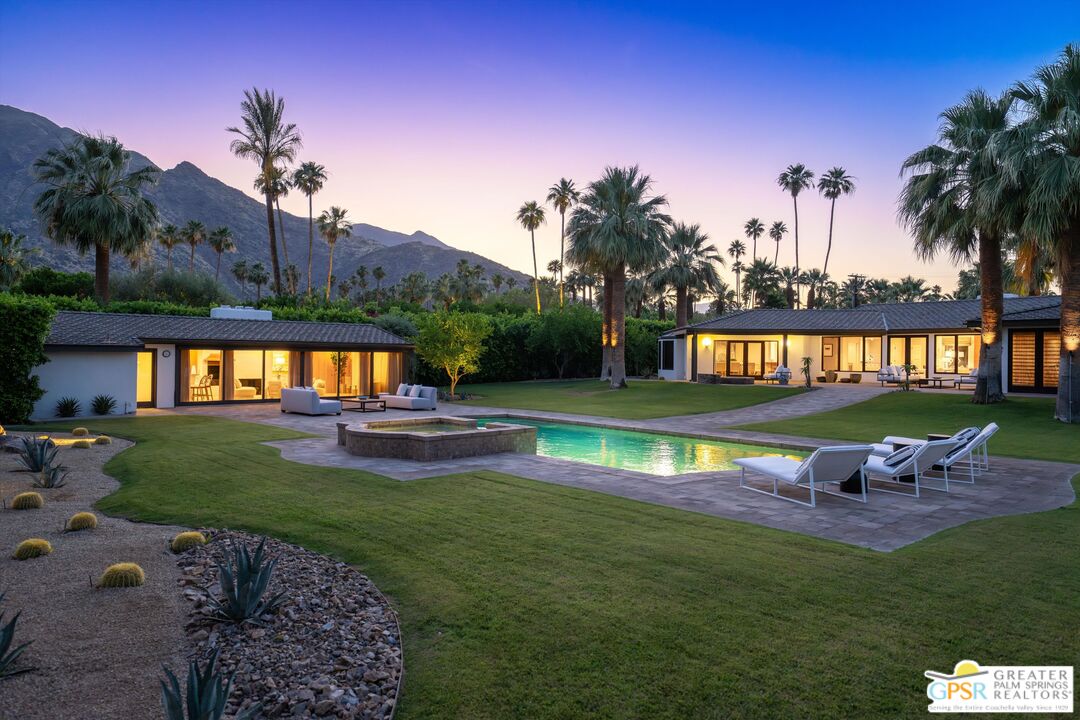 a swimming pool with barbeque oven outdoor seating yard and green space