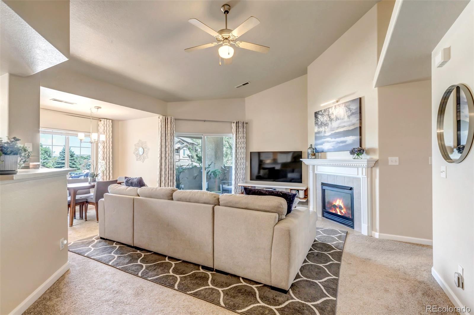 a living room with furniture a fireplace and a flat screen tv