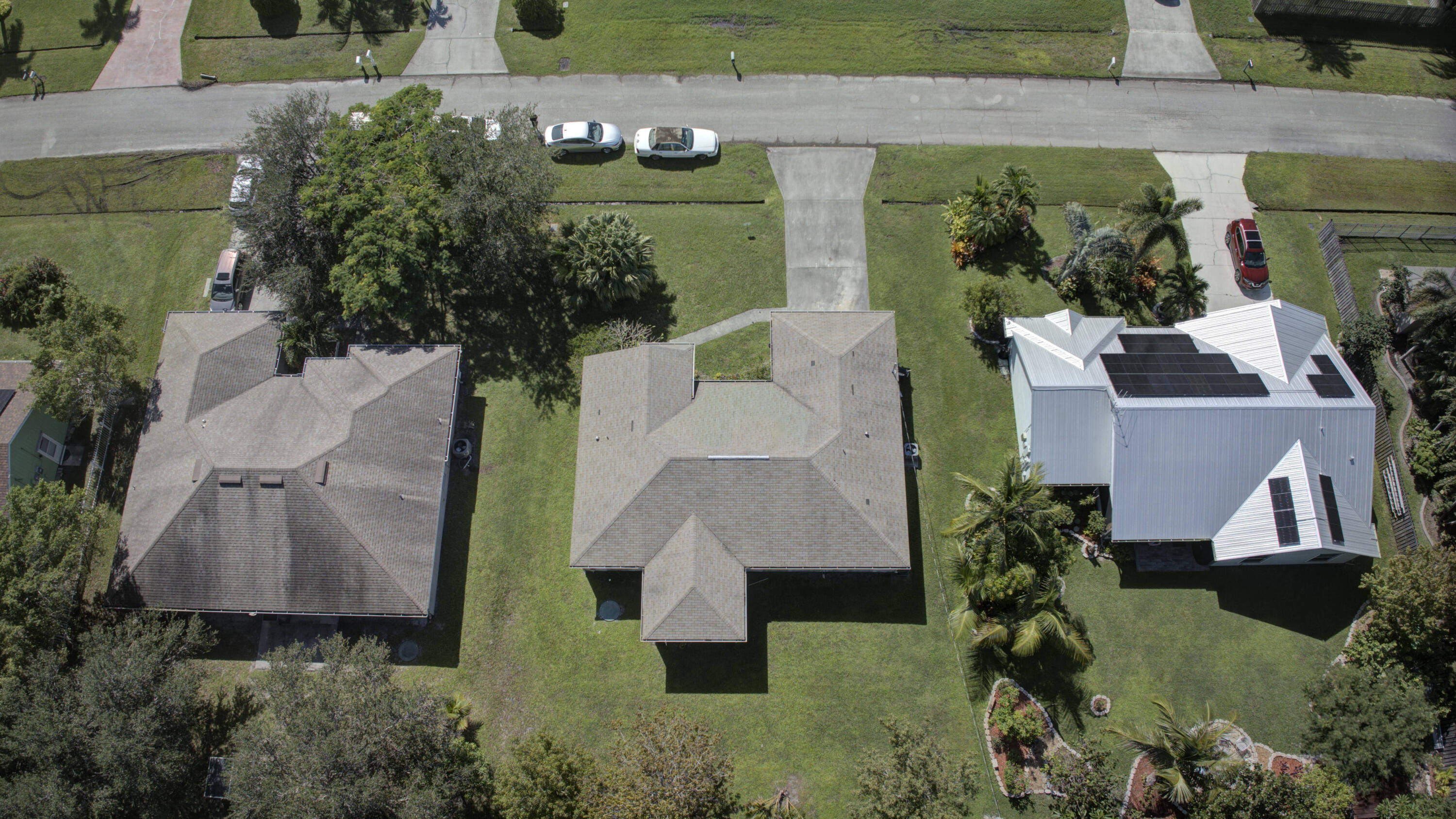 an aerial view of a house with garden space and street view