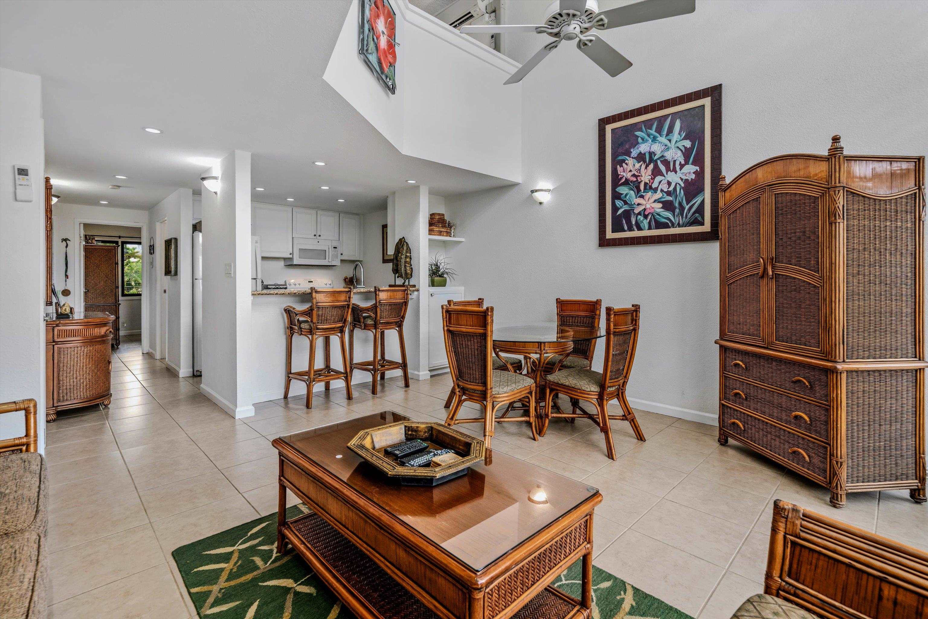 a living room with furniture and kitchen view