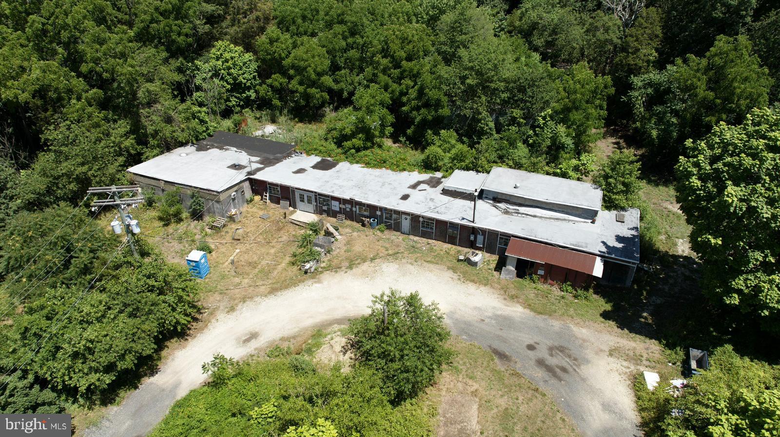 an aerial view of a house with a yard and trees