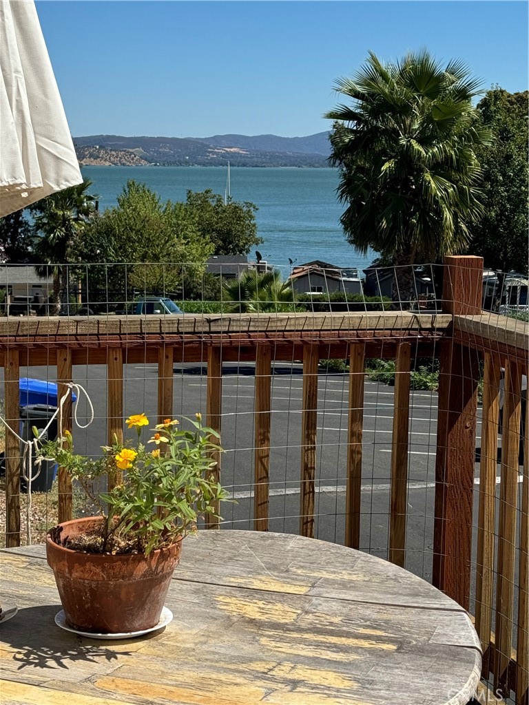 a view of a balcony with chairs and potted plants