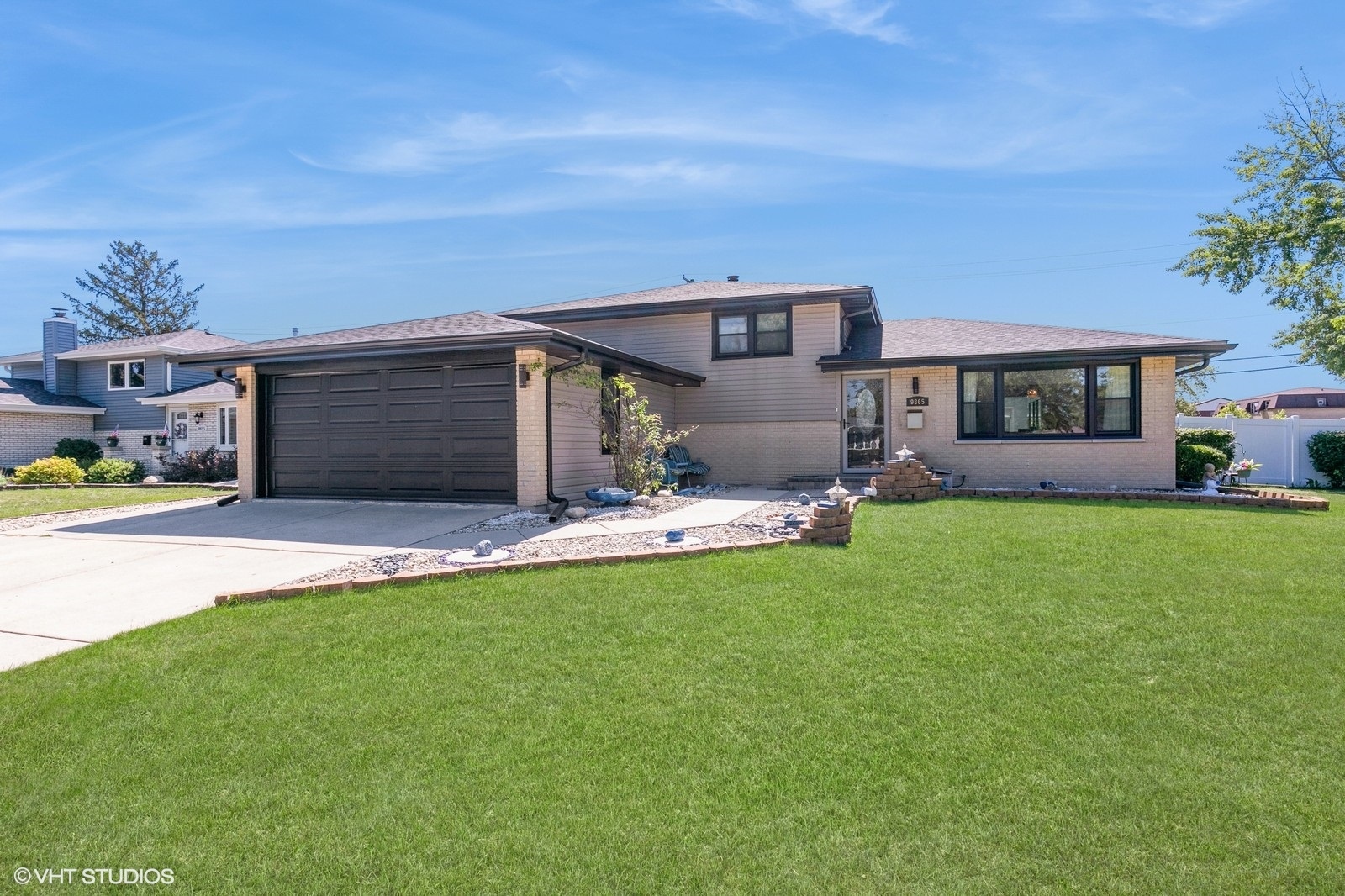 a front view of a house with a garden and yard