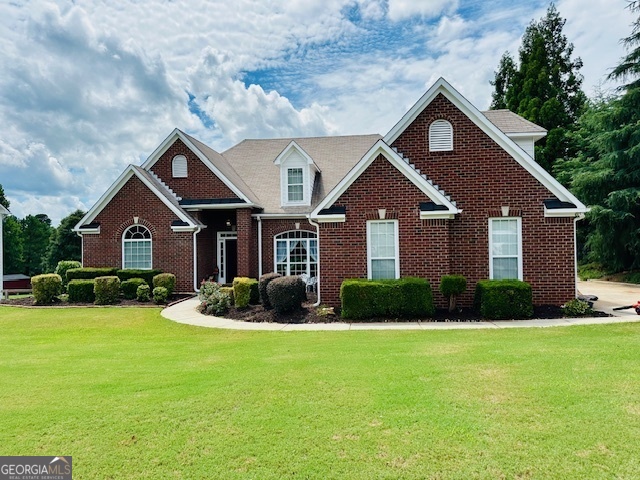 a front view of a house with garden