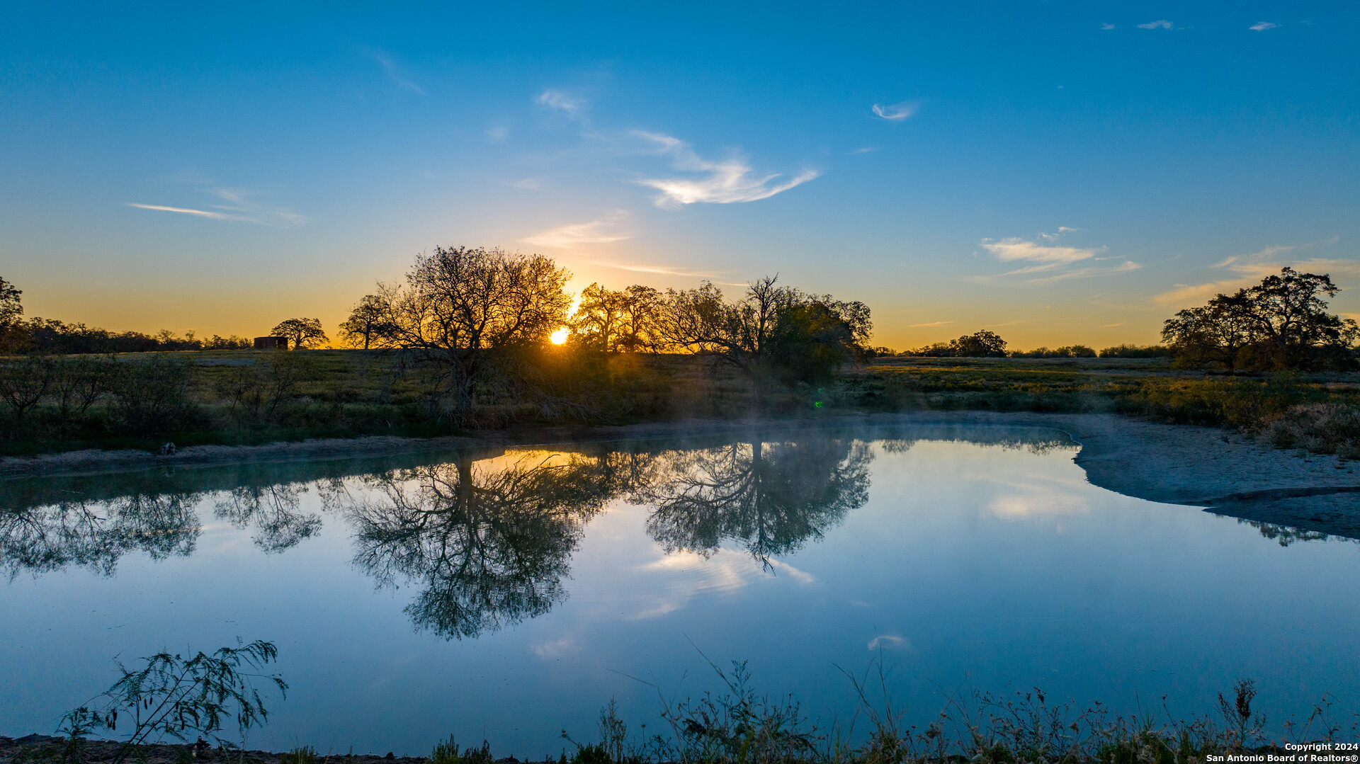 a view of lake with green space