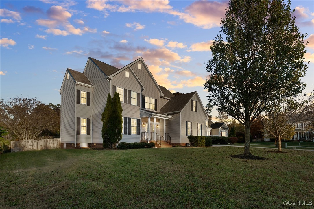 View of front of house featuring well kept lawn