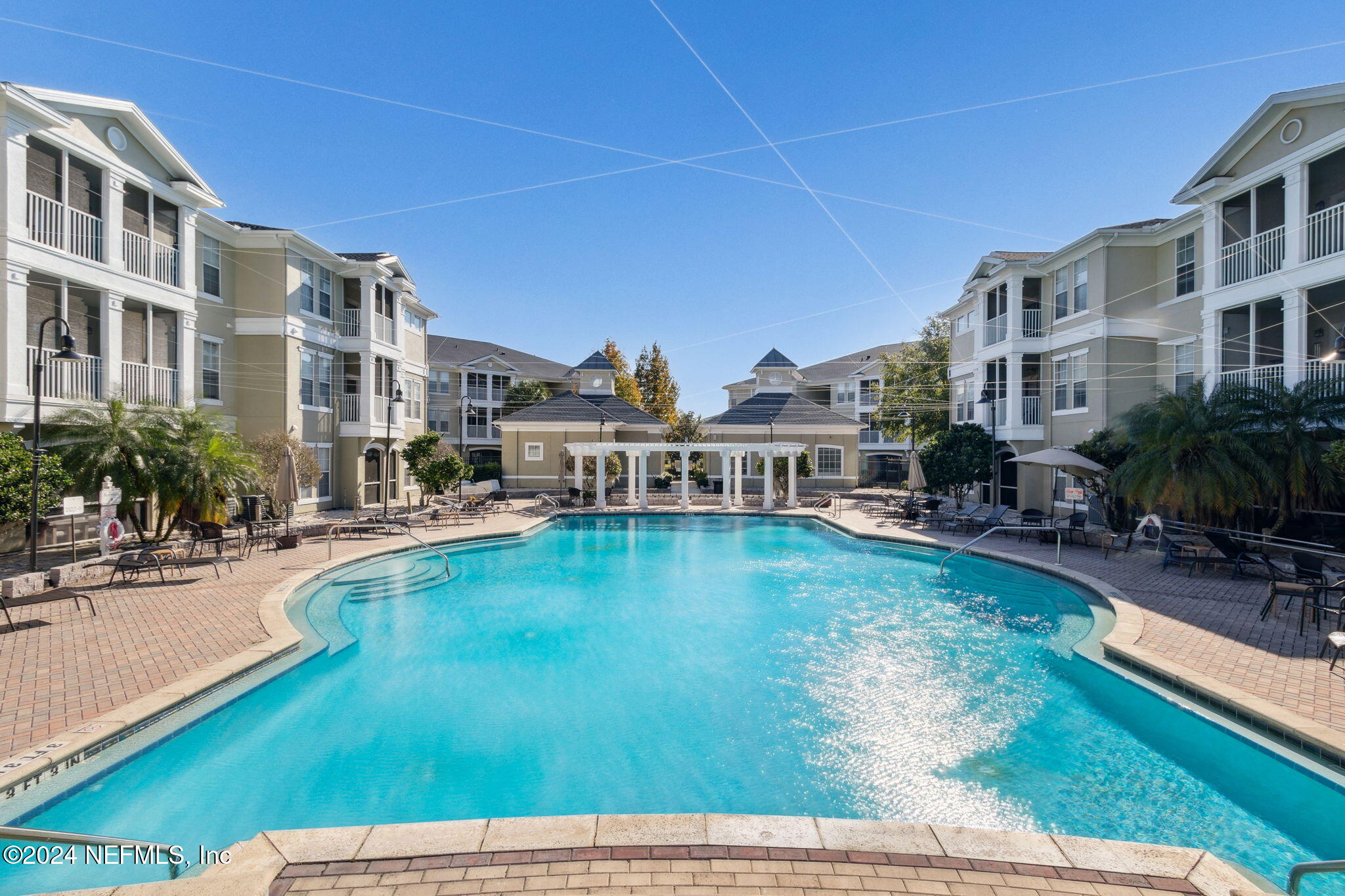 a view of a swimming pool with outdoor seating