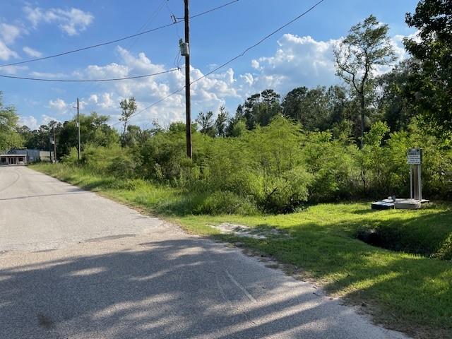 a view of a road with a big yard