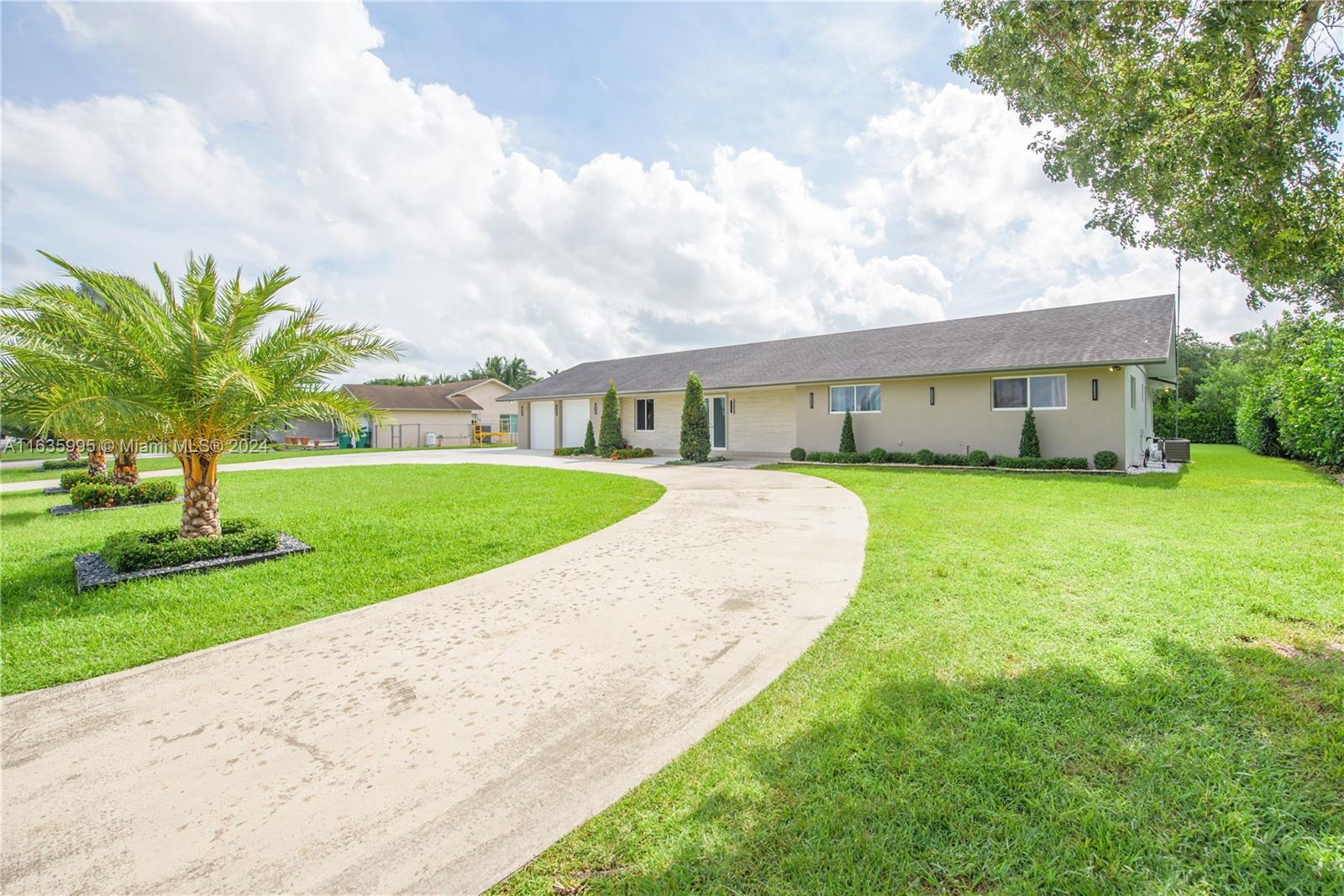 a view of a house with a swimming pool and a yard