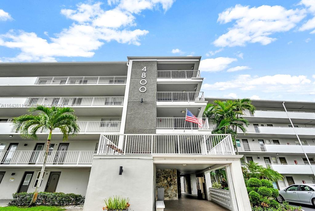 a front view of a residential apartment building with a yard