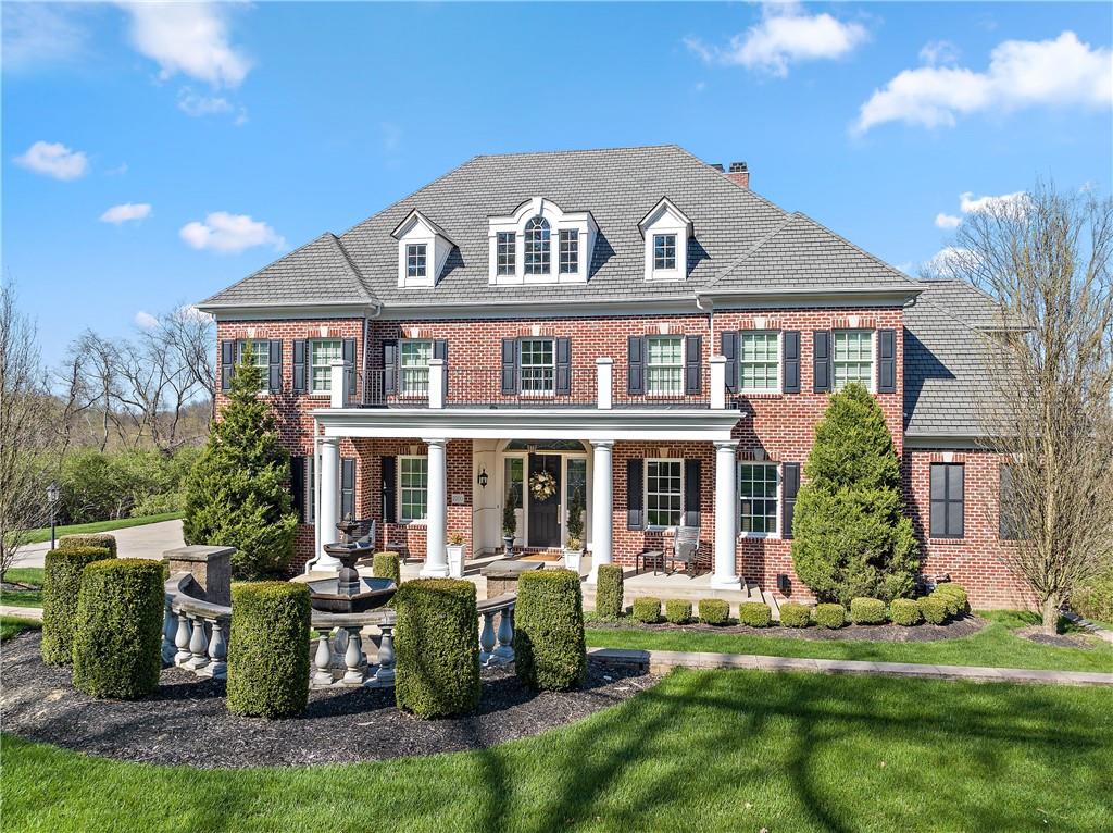 a front view of house with yard and green space