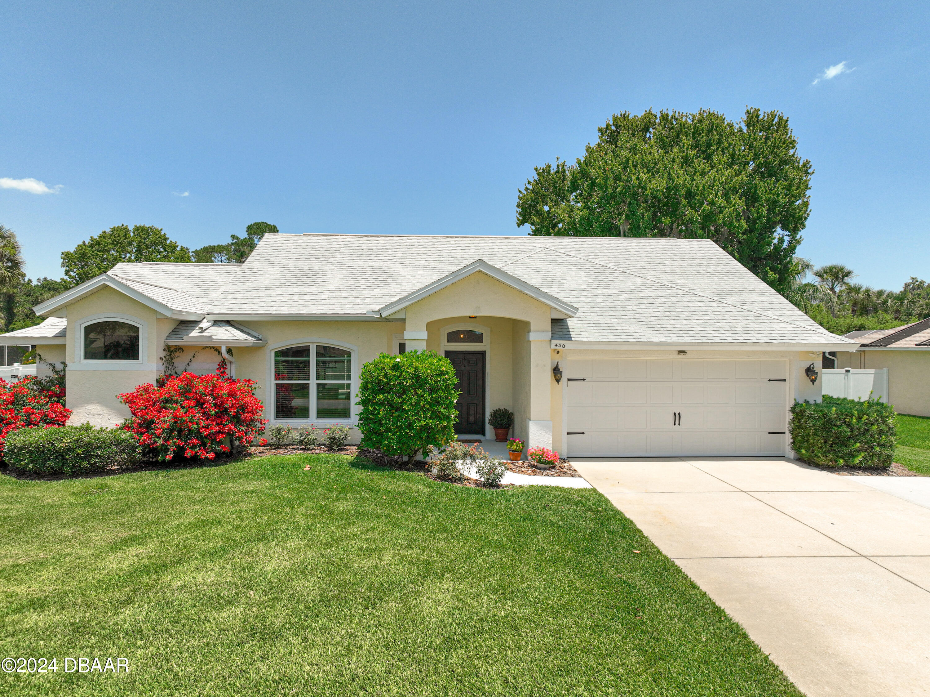 a front view of house with yard and green space