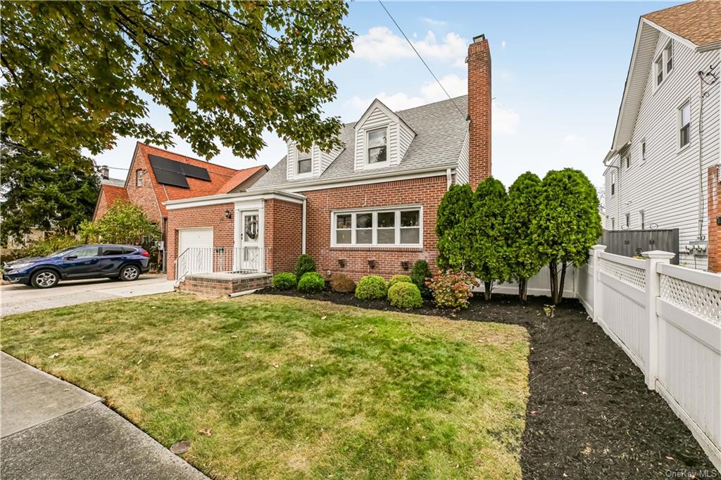 New england style home featuring a front lawn