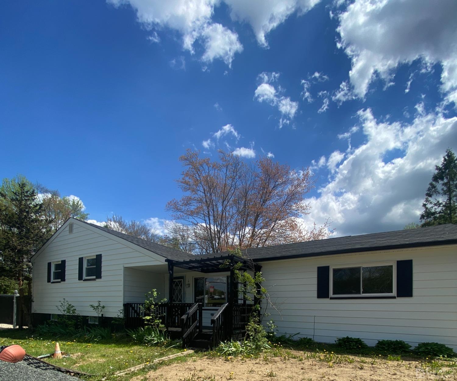 a view of a house with backyard porch and sitting area