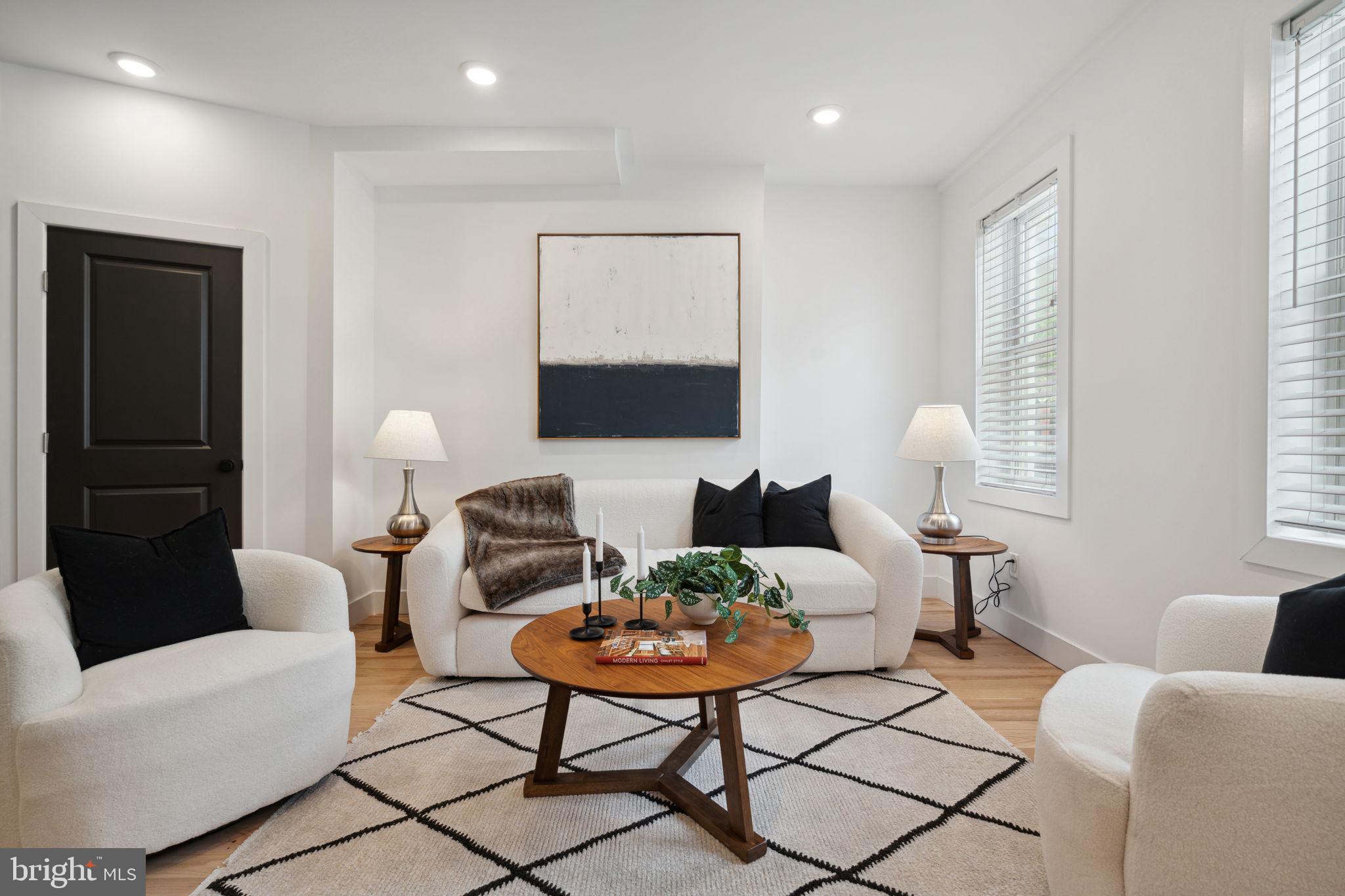 a living room with furniture a rug and a window