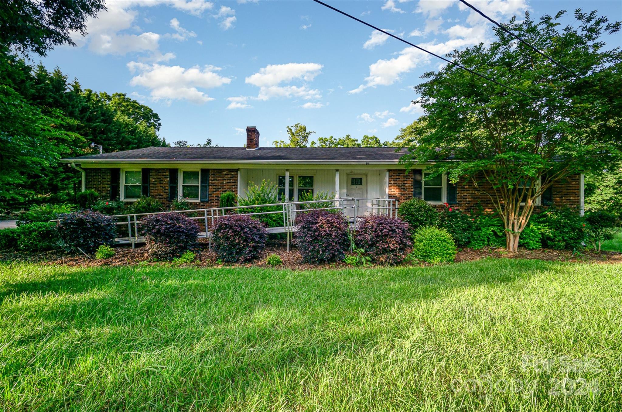 a front view of house with a garden