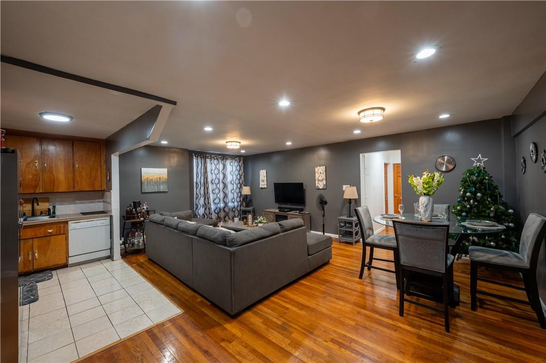 Living room with light hardwood / wood-style floors and sink