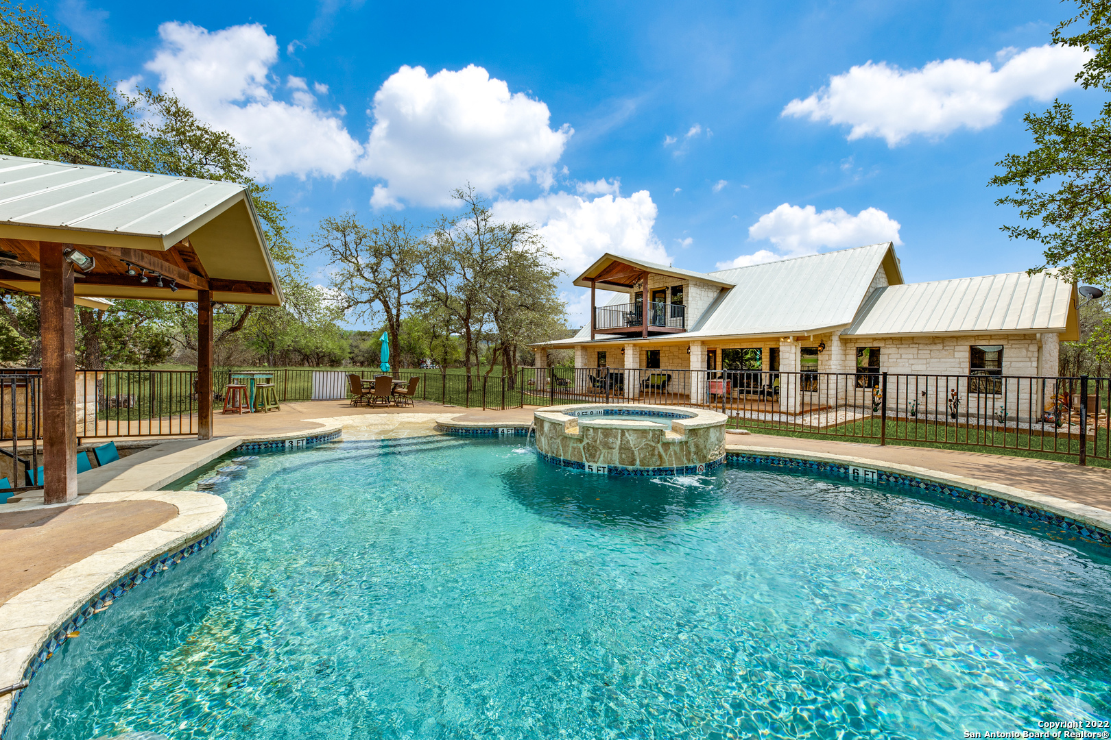 a view of a house with swimming pool and porch with furniture