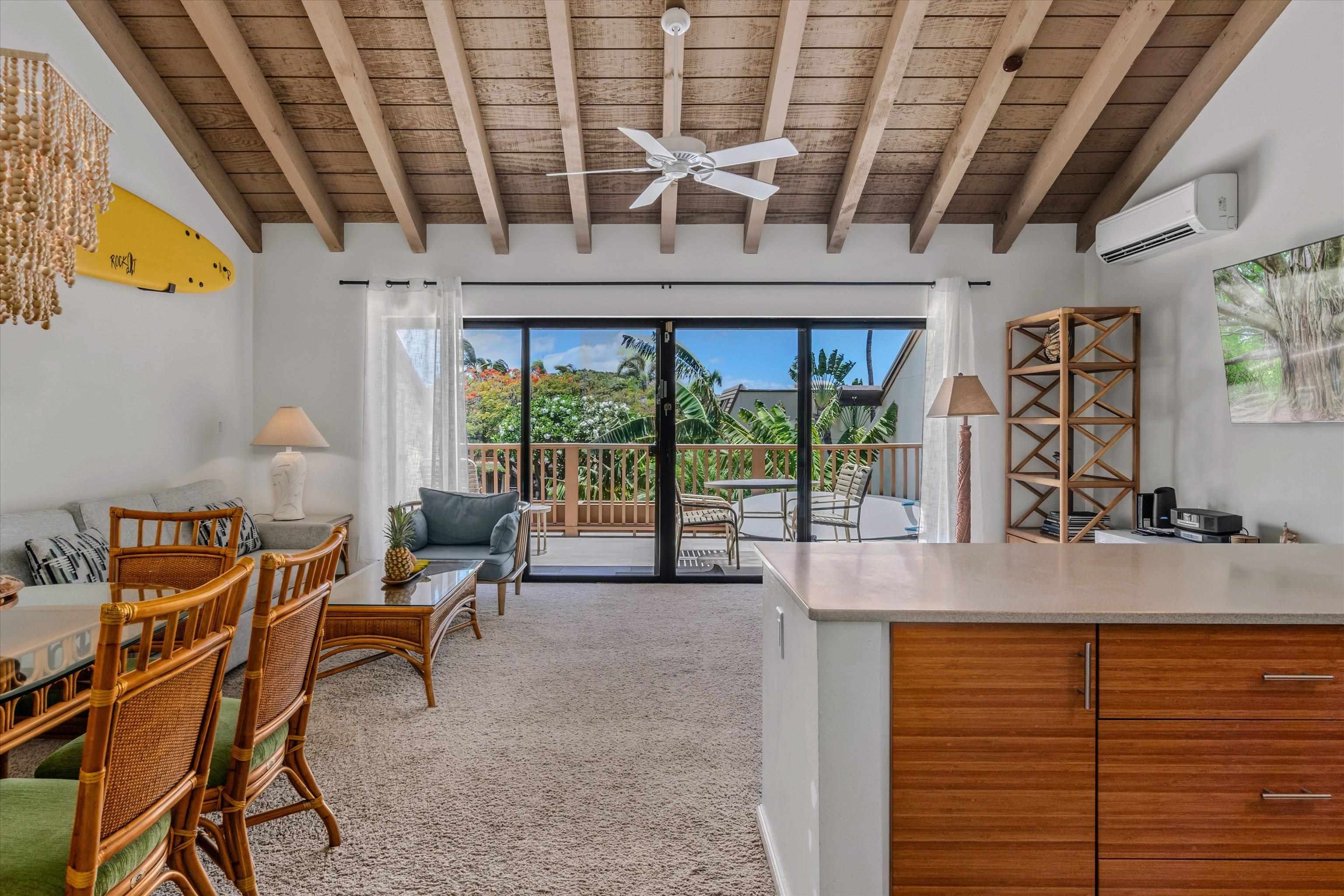 a dining room with furniture and a floor to ceiling window