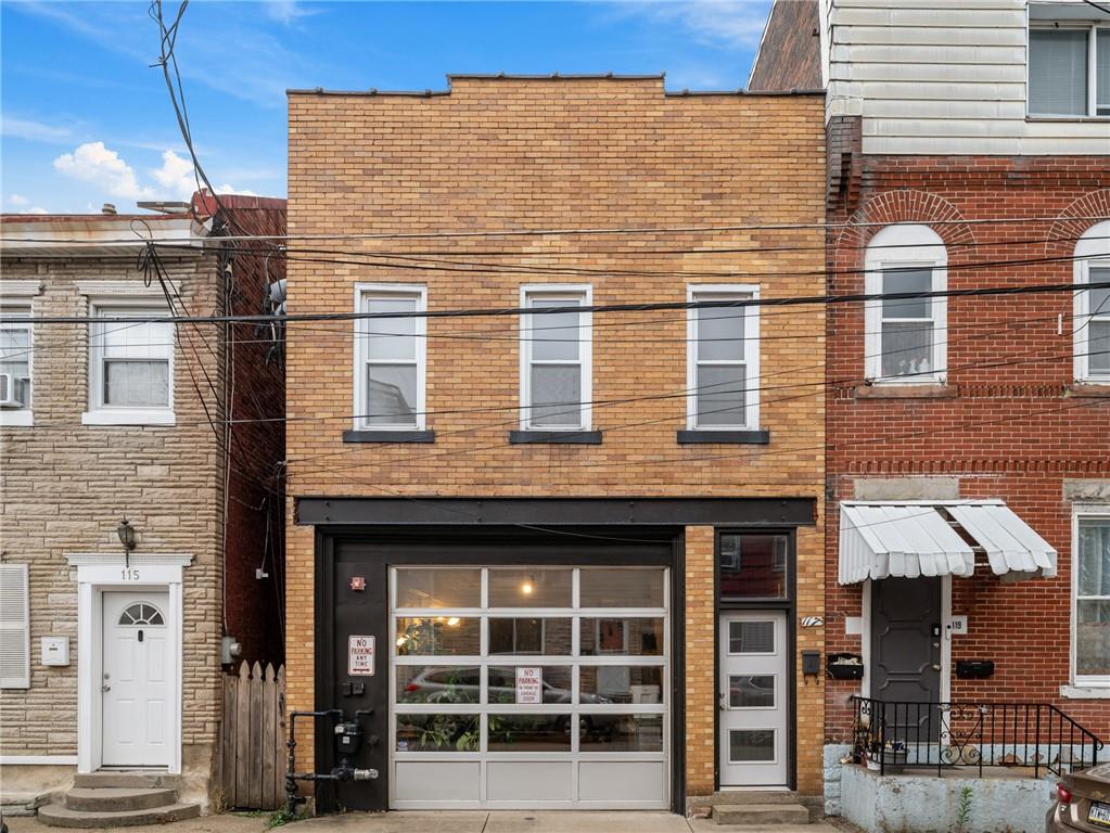 a view of a brick building with many windows