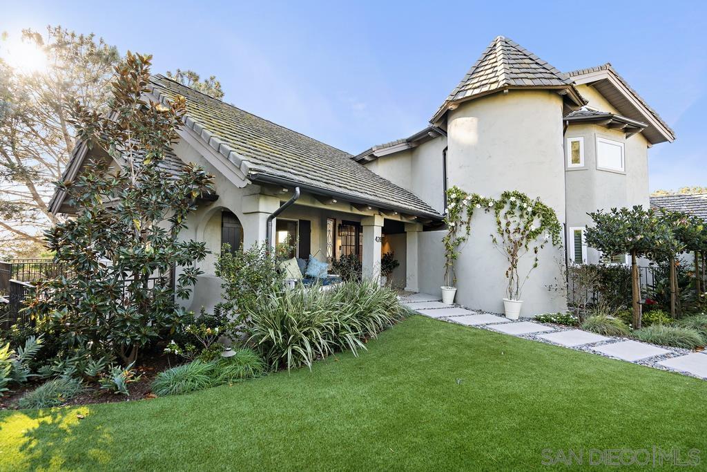 a front view of a house with a garden and plants