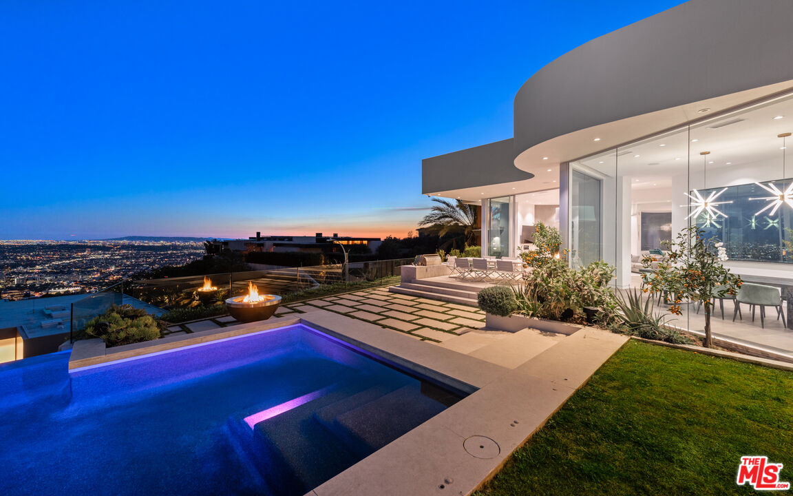 a view of swimming pool outdoor seating and city view