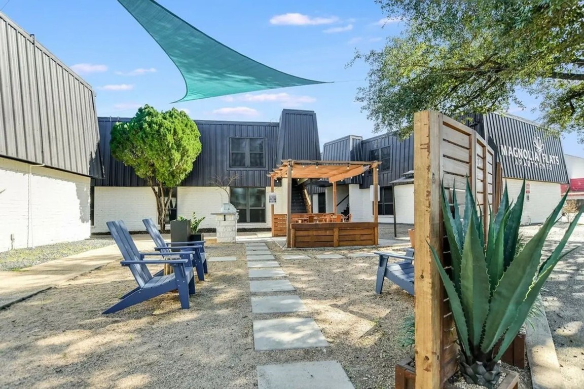 a view of a house with backyard and sitting area