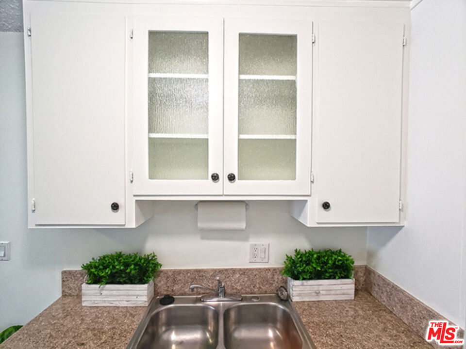 a kitchen with a sink and cabinets