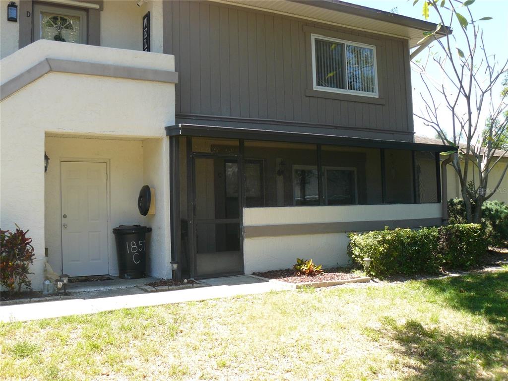 Front of townhouse. Entry door on screened porch