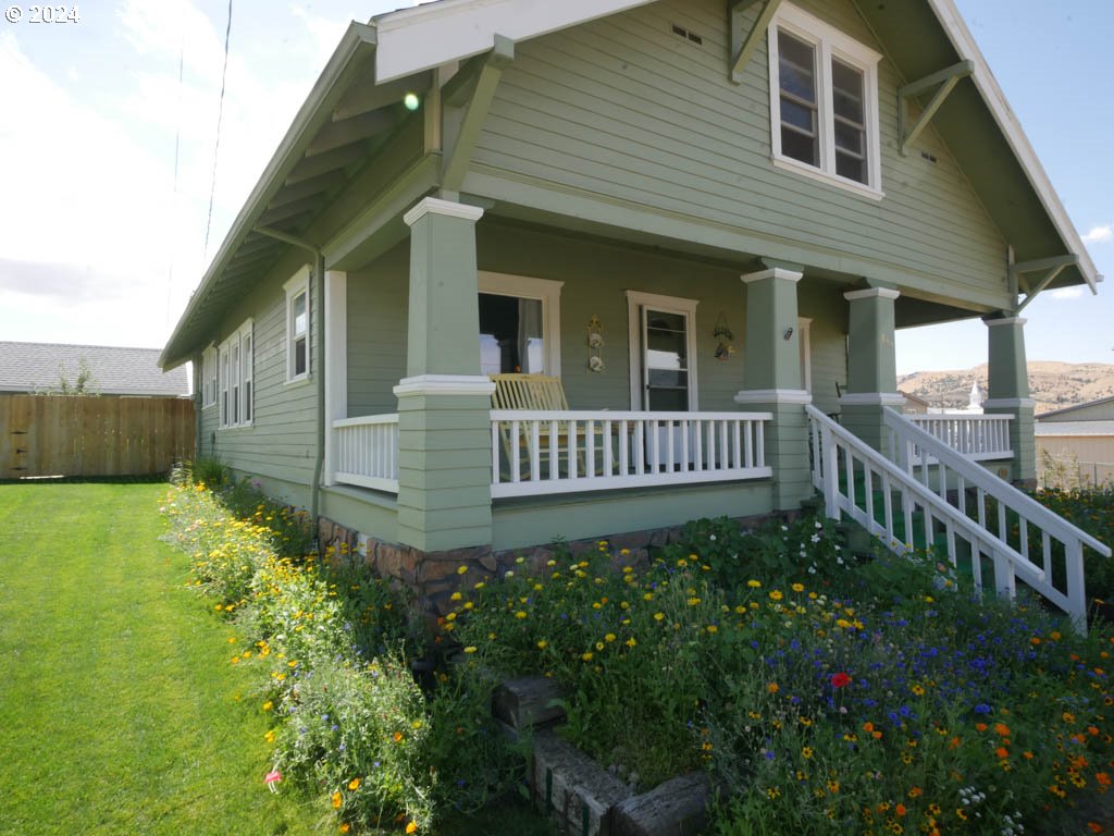 a view of a house with wooden fence