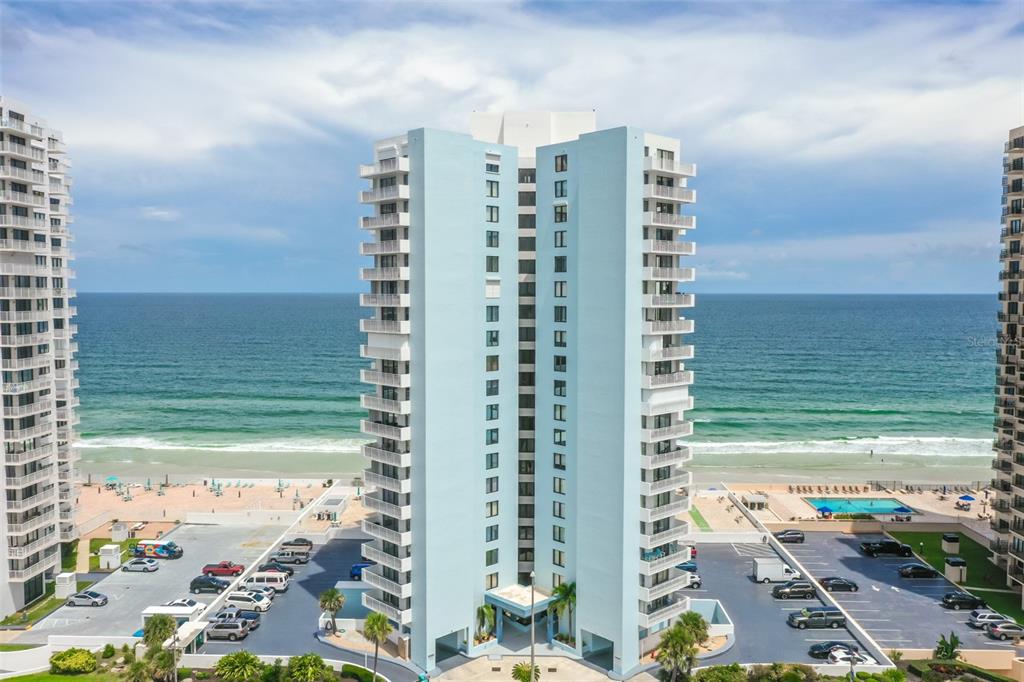 a view of ocean with a multi story building