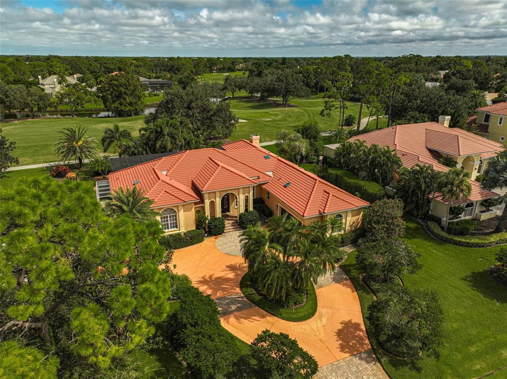 an aerial view of a house with garden space and lake view