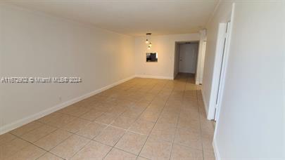 a view of a hallway with wooden floor and a bathroom