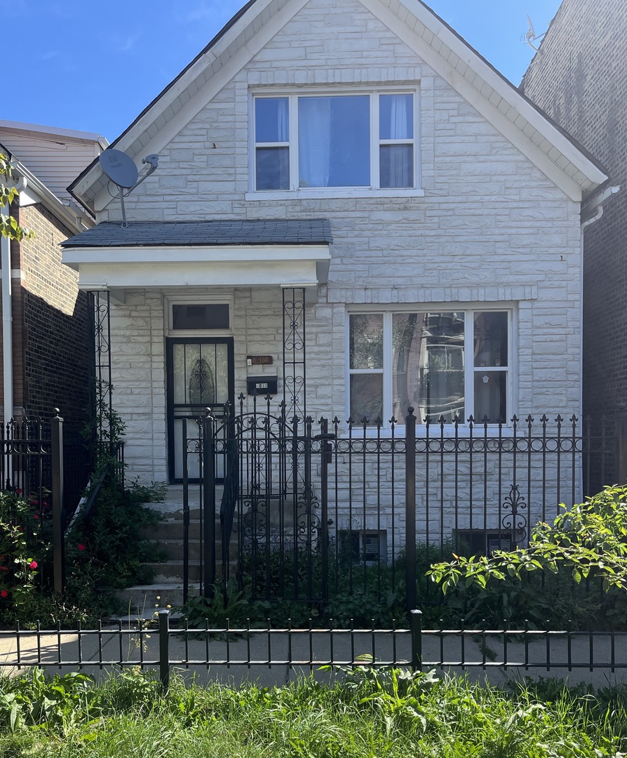 a front view of a house with a garden