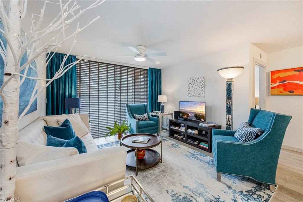 Living room featuring ceiling fan and luxury vinyl flooring